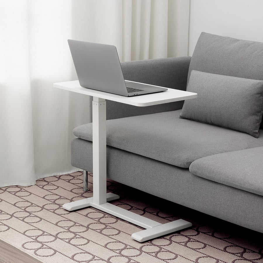 IKEA BOLLSIDAN laptop stand beside a sofa with laptop
